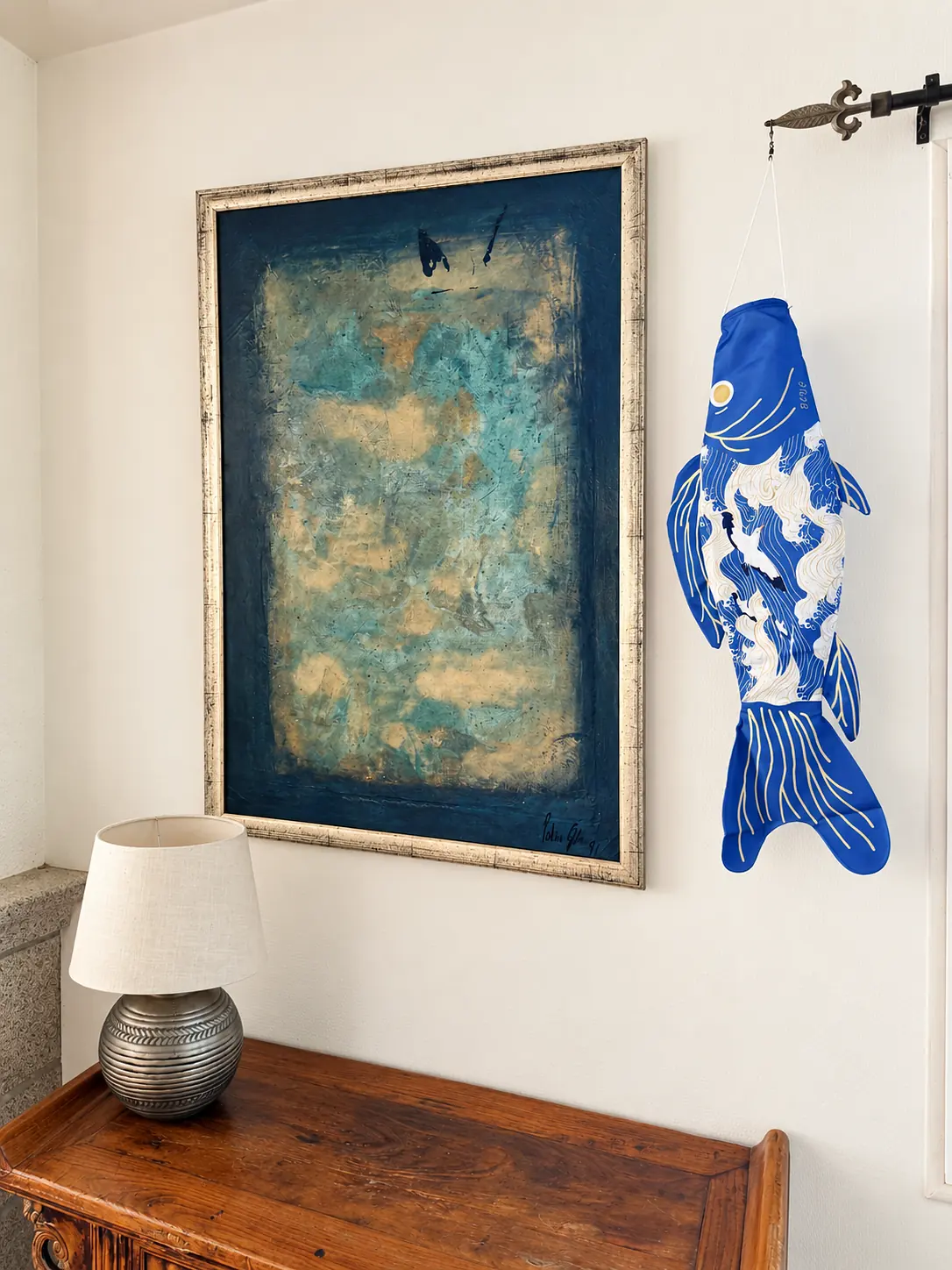 Vagues et Mouettes hanging from a curtain rod in a bright living room, next to a painting